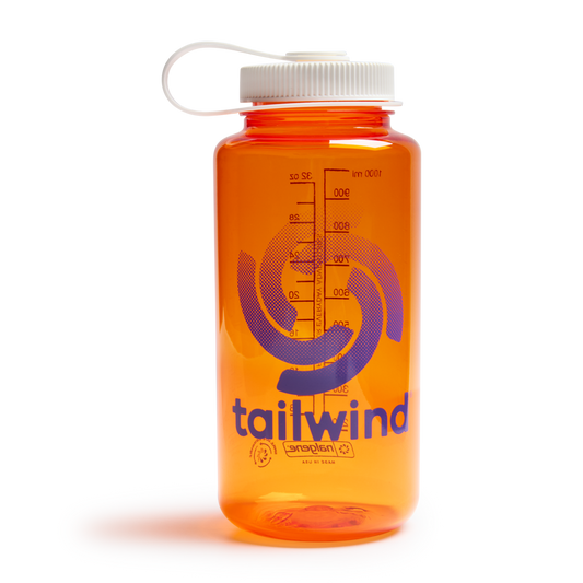 Product photograph of a Tailwind Nalgene water bottle featuring a translucent orange plastic body, a purple swirling graphic logo, and a white tethered screw-top lid against a black background