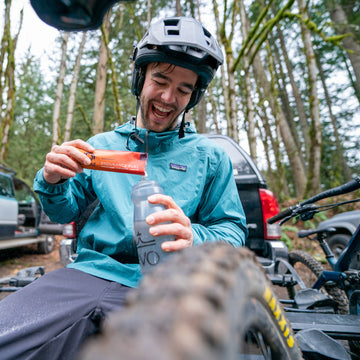 Mountain biker pouring Endurance Fuel